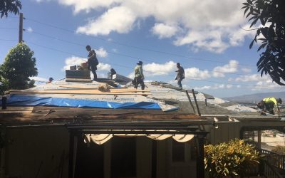 ProBuilt Hawaii crew installing CertainTeed underlayment during a residential roof replacement under clear skies