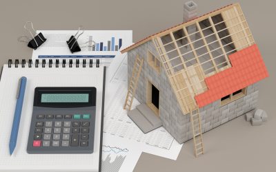 Calculator and itemized cost sheets for comparing roof replacement quotes, next to a model house with a partly tiled roof
